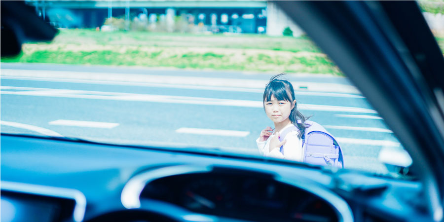 通学中の女の子と車　気づかれにくい走行音イメージ